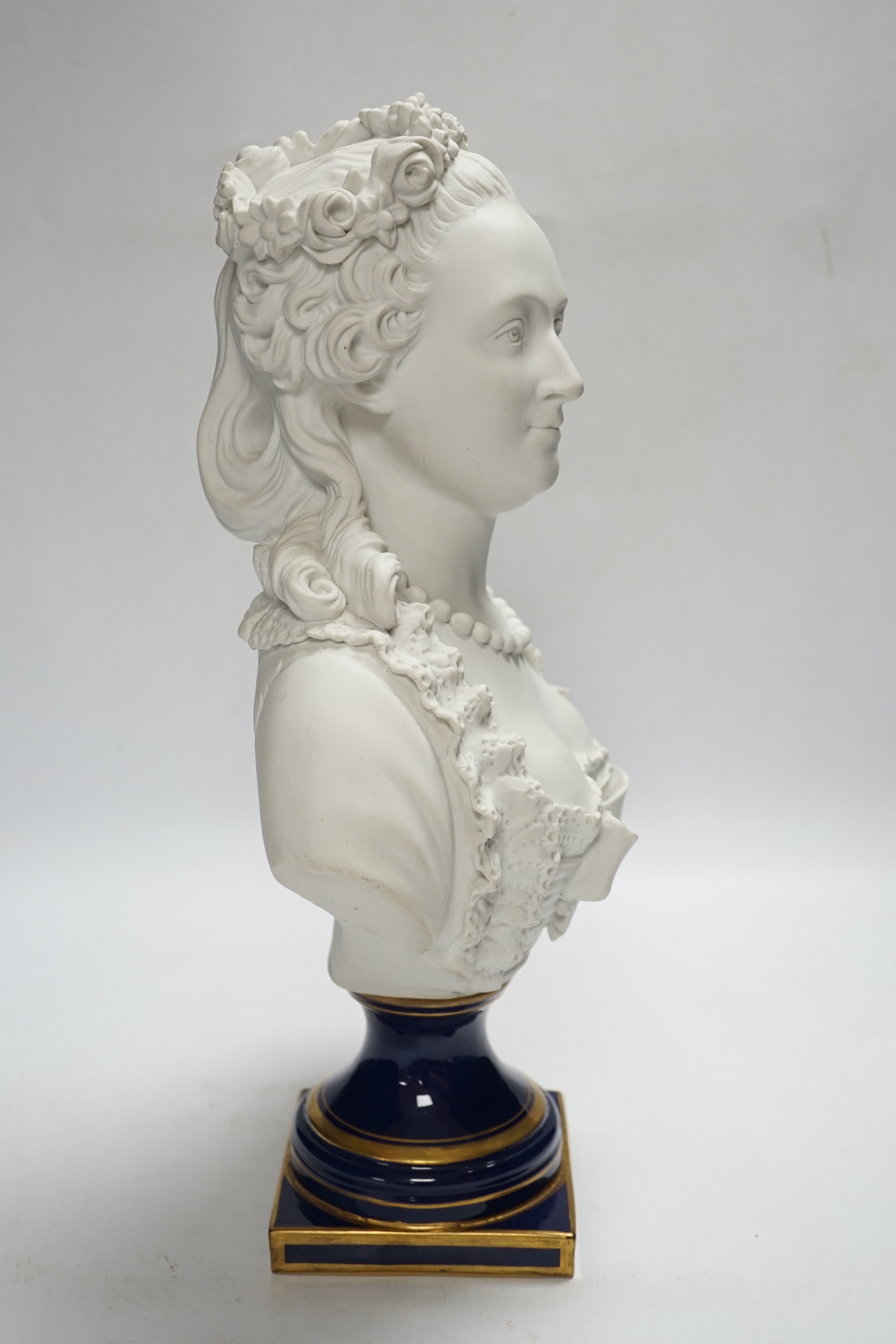 A Sevres style biscuit porcelain bust of a courtesan, 42cm high